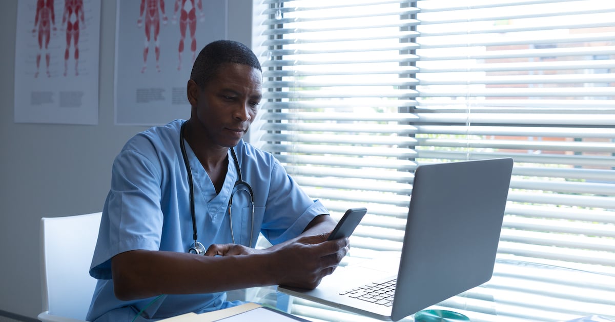 surgeon texting at desk