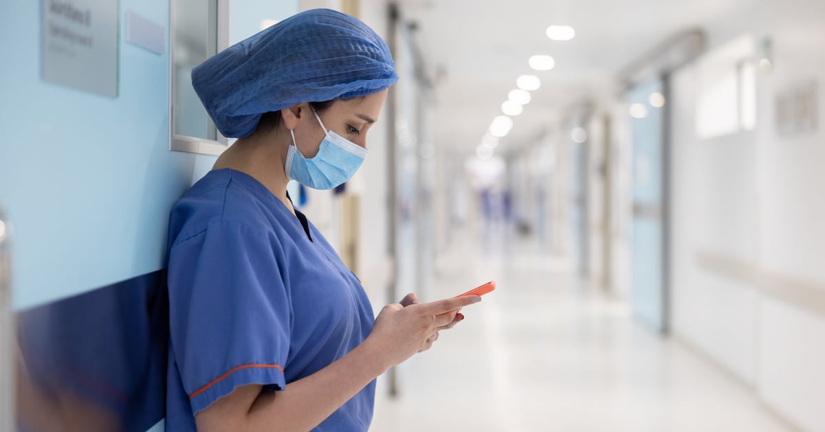 nurse texting outside the operating room